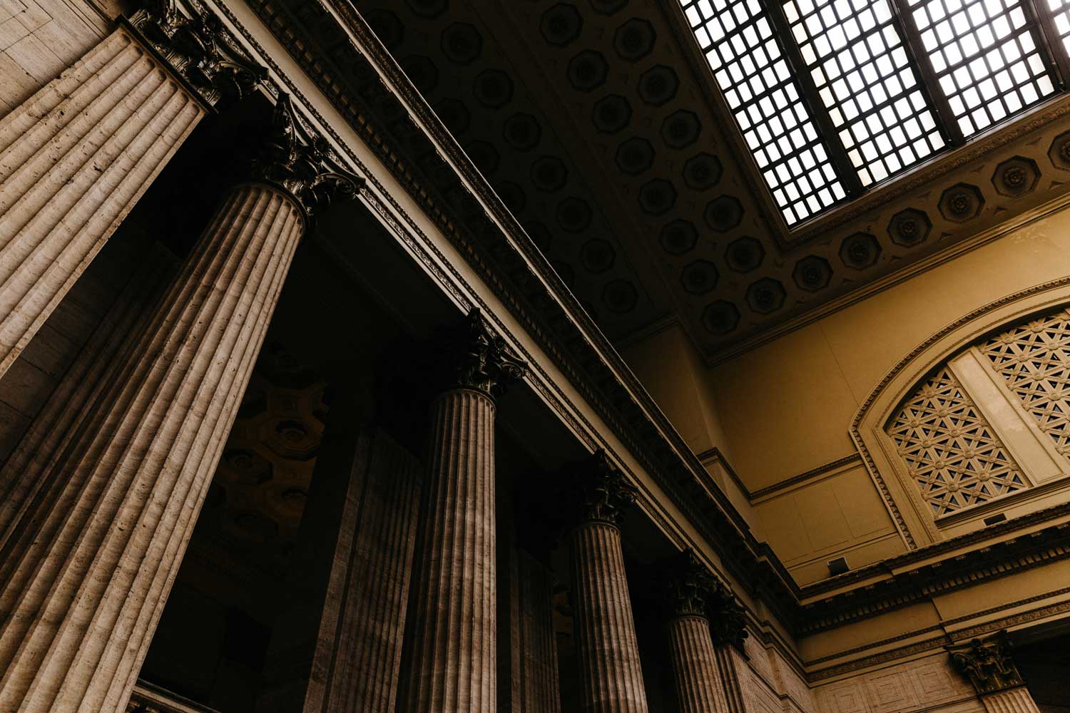 interior of old court house with tall pillars and windows